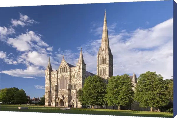 Evening sunshine glows on the ornate facade of Salisbury Cathedral, Wiltshire, England