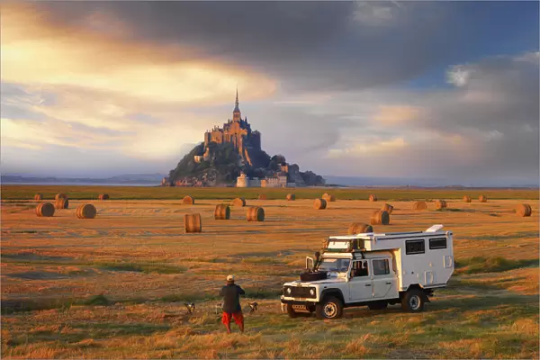 France, Normandy, Le Mont Saint Michel, Man and truck in hay field