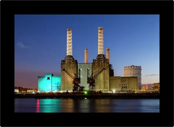 United Kingdom, UK, London, Battersea power station illuminated by colored light at dusk