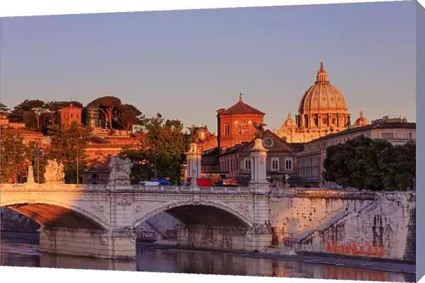 Italy, Rome, St. Peter Basilica at sunrise reflecting on Tevere river
