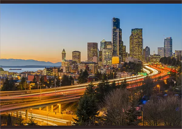 Freeway traffic and downtown skyline at dusk, Seattle, Washington, USA