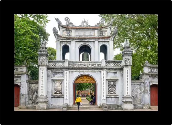 Woman walking through gate at Temple of Literature, Dong Da District, Hanoi, Vietnam