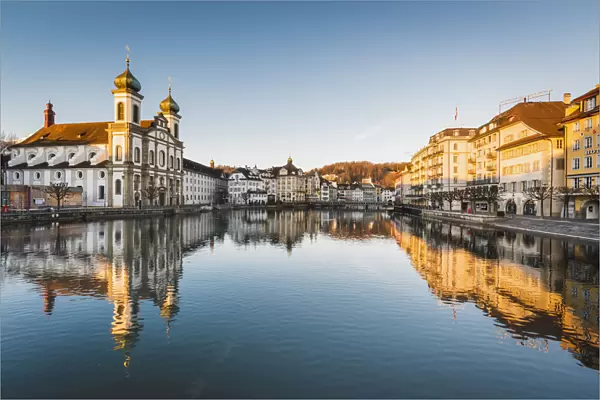 Lucerne, Switzerland. Jesuit church and Reuss rivers waterfront at sunrise