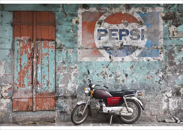 Mauritius, Port Louis, Chinatown, motorbike in front of Pepsi sign