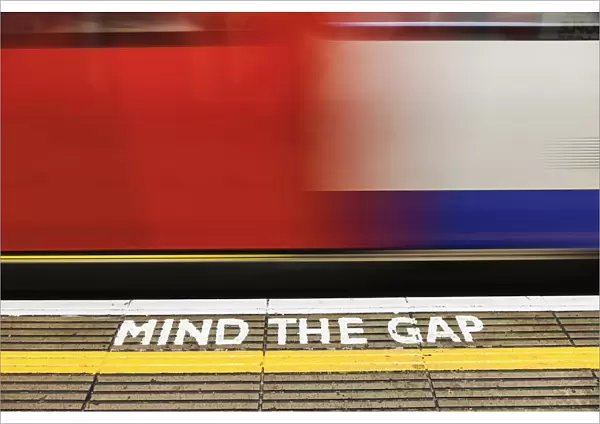 England, London, The Underground, Mind the Gap Sign and Moving Train