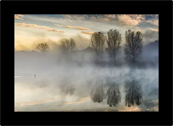 Reflections on Adda river at dawn, Lecco Province, Lombardy, Italy