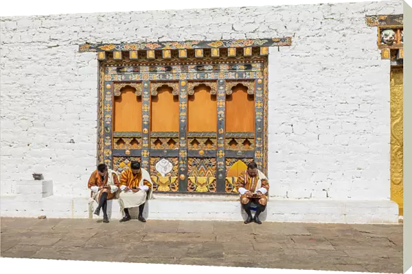 People sitting at the Punakha Tshechu (otherwise known as Punakha Festival)