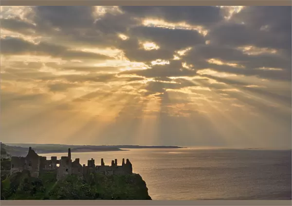 Sunrays over Dunluce Castle at Sunset, County Antrim, Northern Ireland