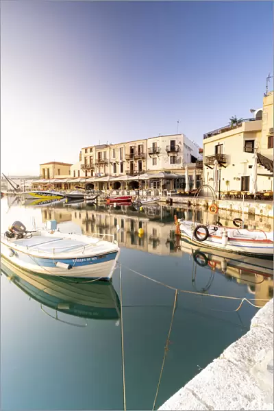 Fishing boats moored in the old Venetian harbour at dawn, Rethymno, Crete island, Greece
