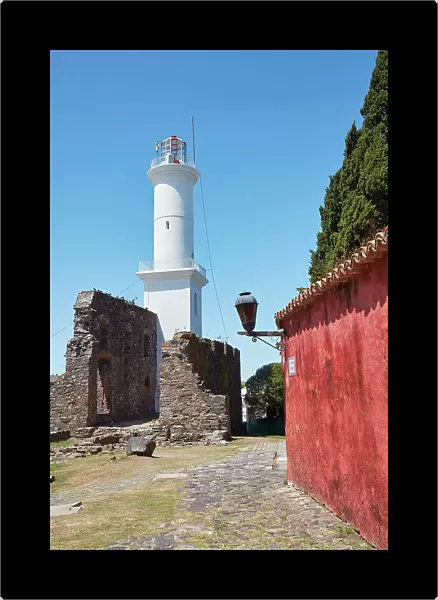 The lighthouse and a Portuguese traditional house in the historical cask of Colonia del Sacramento, Uruguay. Colonia was declared UNESCO World Heritage Site in 1995