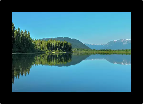 Coast Mountains reflected in Tattoga Lake near Iskut along the Stewart Cassiar Highway, British Columbia, Canada