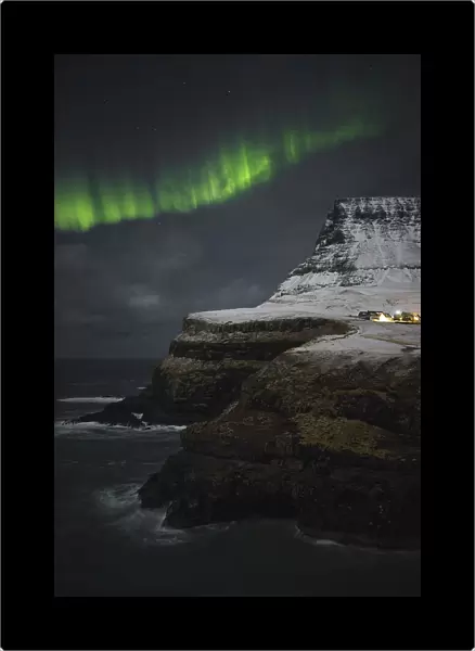 Norther lights dancing above the village of Gasadalur. Island of Vagar. Faroe Islands