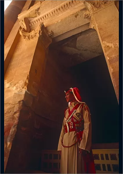 Jordan, Petra. A Jordanian policeman stands at the entrance to Petras famous Treasury