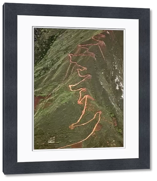 Peru. A trail zigzags up a steep ridge on the Andean Mountains east of Cusco
