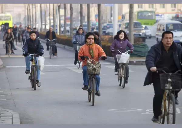 Cyclists and cars in Beijing. Increasinlgy the chinese as they become wealthier change from cycles to cars, a move that has been partly responsible for pushing china in 2008 into becoming the worlds largest emmitter of greenhouse