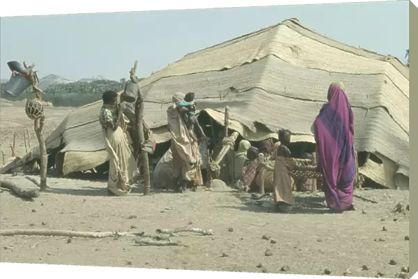 20053811. SUDAN Tribal Peoples Beja women and children outside tent made