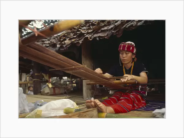 20063639. THAILAND Chiang Mai Sgaw Karen woman weaving cloth on a back strap loom