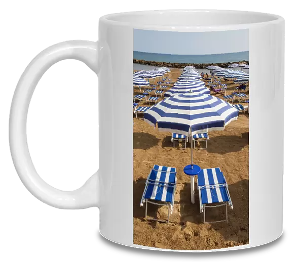Italy, Sicily, Marina Di Ragusa, Sun umbrellas and sun beds on a beach