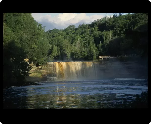 10006370. USA Michigan Chippewa Tahquamenon Falls waterfall surrounded by lush greenery