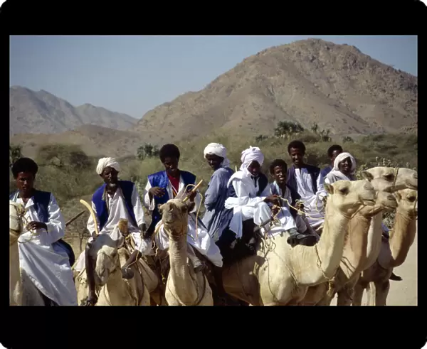 20040128. ERITREA Nomadic People Nomads riding camels on road between keren