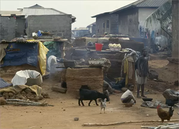 20075485. GHANA Village Scene Outside ovens in village near Accra with children goats