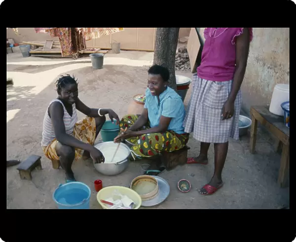 20061384. BURKINA FASO Ouagadougou Girls stirring milk