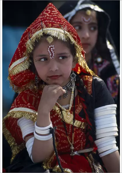 INDIA, Rajasthan, Alwar Young girl dancer wearing traditional jewellery at the Alwar