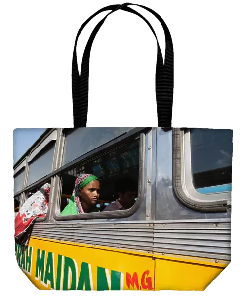 India, West Bengal, Kolkata, A passenger at the window of a public bus