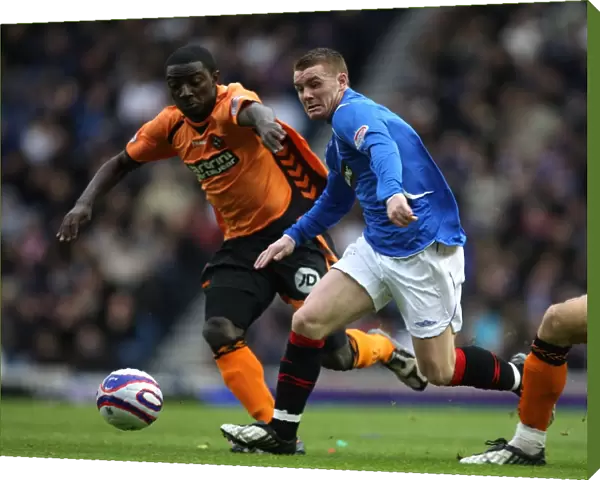 Rangers vs Dundee United: A Tight Battle for the Ball - John Fleck vs Prince Buaben at Ibrox Stadium (2-0 in Favor of Rangers)