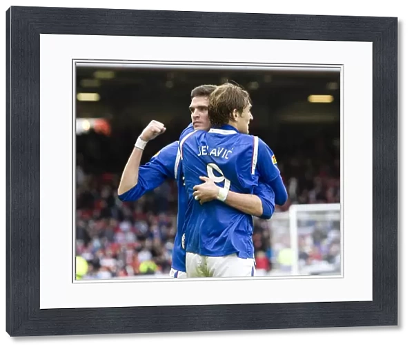 Rangers Lafferty and Jelavic: Celebrating a Hard-Fought 2-1 Victory at Pittodrie Stadium