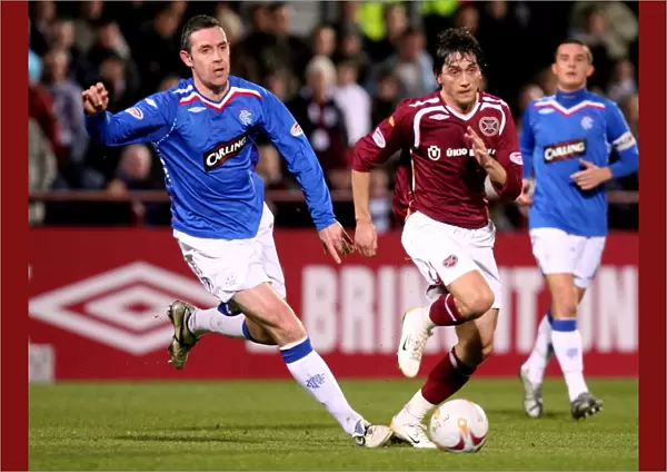 David Weir and Deividas Cesnauskis in Action: Rangers 4-0 Triumph over Heart of Midlothian at Tynecastle Stadium (Clydesdale Bank Premier League)