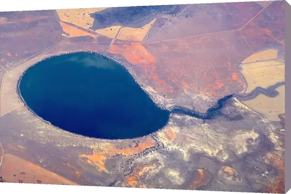 An aerial view of a large lake surrounded by agricultural farming land in south-western