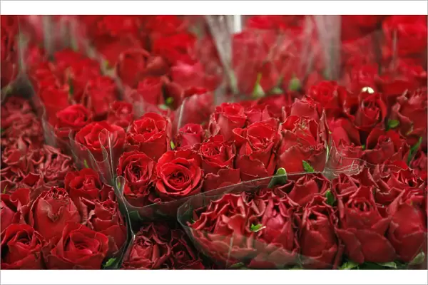 Bunches of red roses are displayed on a stall at New Covent Garden Market a day before