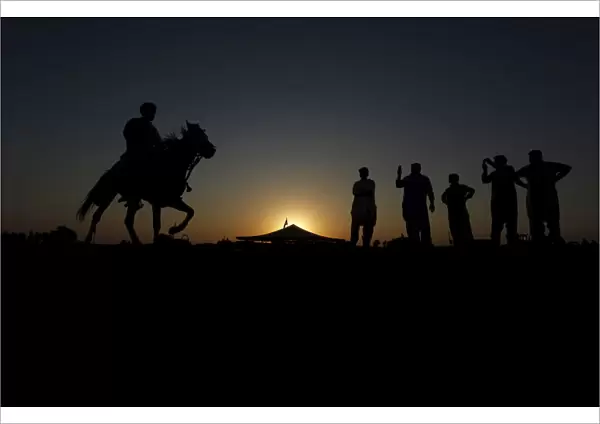 Competitors prepare for horse race as they pay homage at the shrine of the Muslim