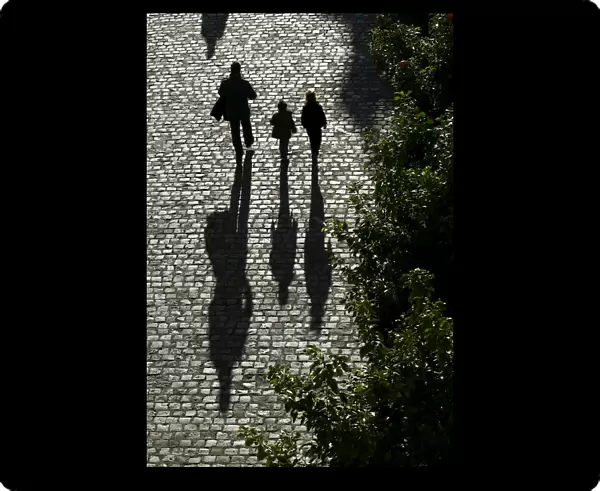 A man and children walk on the street in the Andalusian capital of Seville, southern