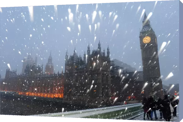 Snow falls around The Houses of Parliament in central London