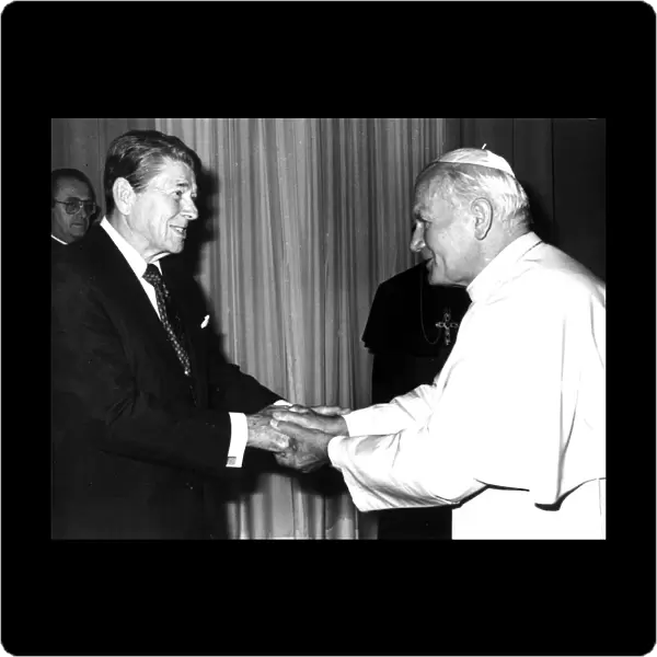 POPE JOHN PAUL II SHAKES HANDS WITH U. S. PRESIDENT REAGAN DURING MEETING AT VATICAN