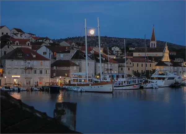 The moon rises over the town of Milna on the island of Brac