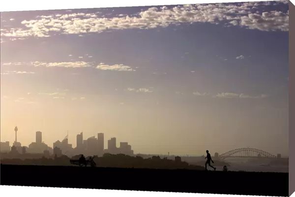 Man walks as another looks towards city of Sydney on hot summers day in Australia