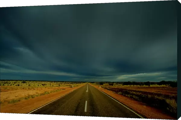 CLOUDS GATHER OVER PETERMANN ROAD IN CENTRAL AUSTRALIA
