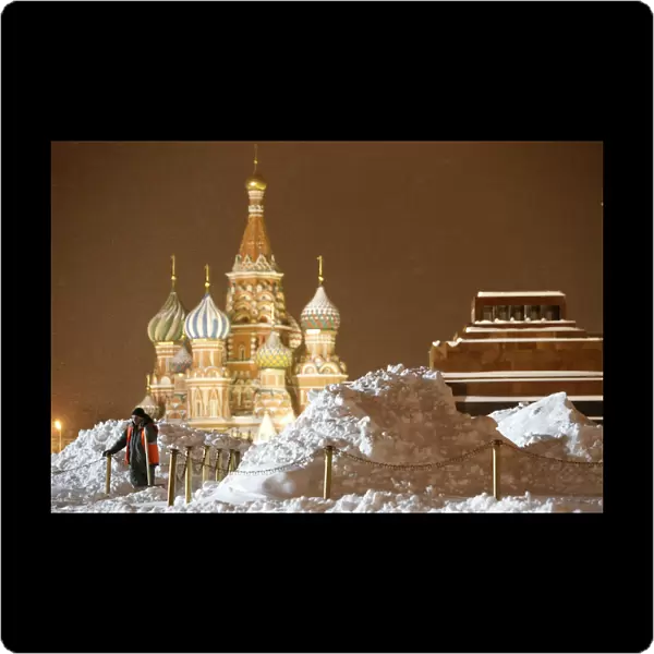 A worker clears and removes snow in Red Square in central Moscow