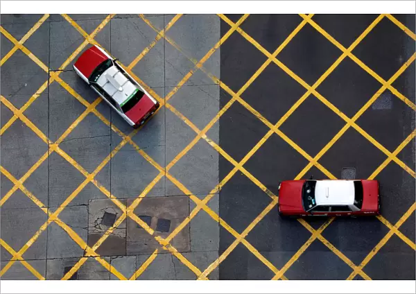 Taxis cross a street near Wan Chai station in Hong Kong