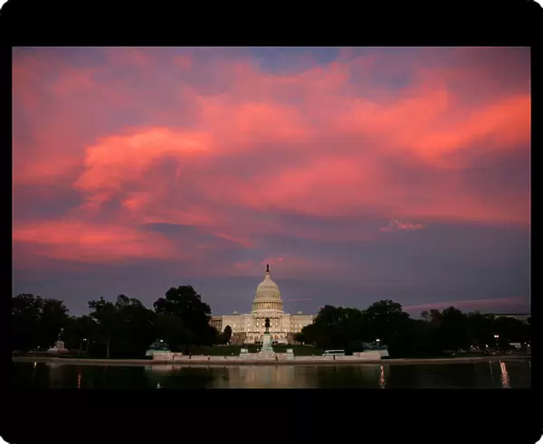 Clouds glow over the Capitol Building at sunset in Washington