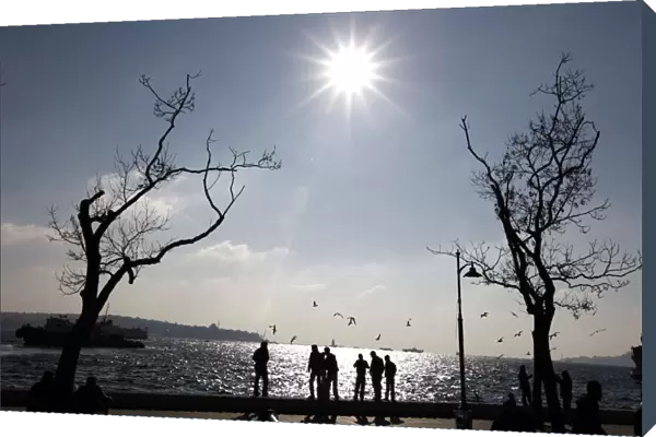 People enjoy sunny weather at a park by the Bosphorus in Istanbul