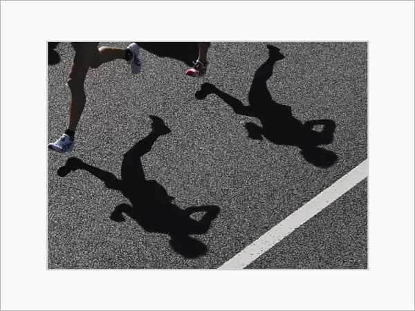 Runners cast their shadows during the 2008 Tokyo Marathon