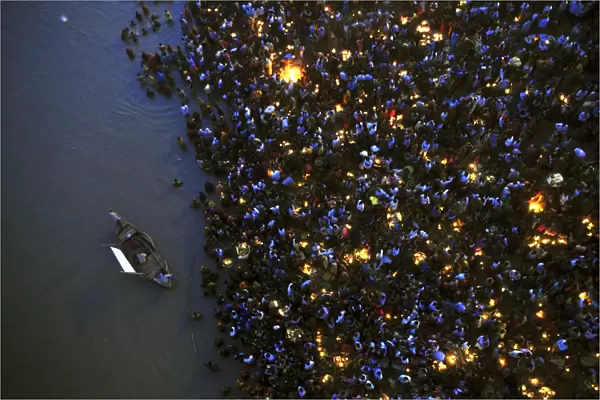 Hindu devotees gather to worship the Sun god Surya on the banks of the Ganges river