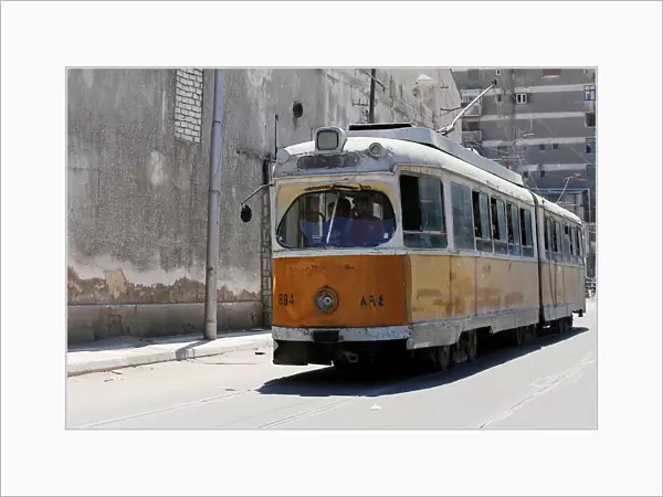 People ride in an old electric tram in Alexandria, Egypt
