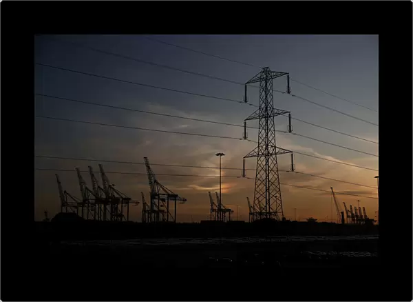 The sun sets behind cranes at the ABP port in Southampton