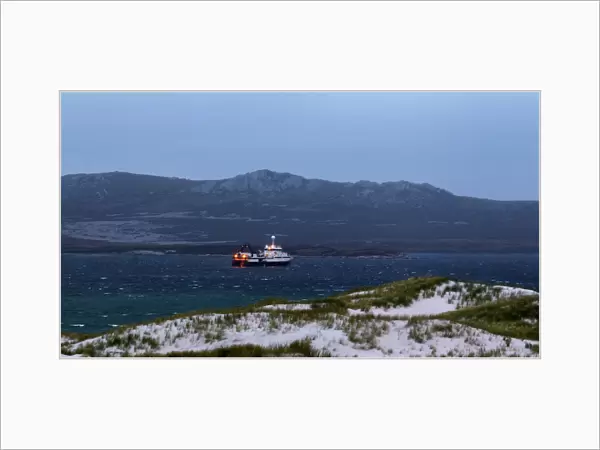 A cargo ship is seen from Gypsy Cave, off the shore of Port Stanley