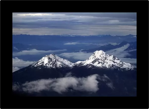 The double peak of the Illinizas are seen from a plane during a flight to Quito